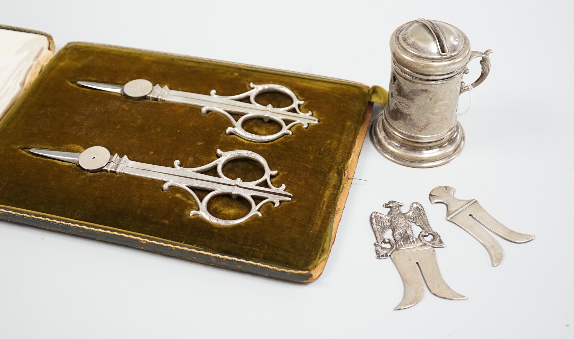 Judaica - a cased pair of scissors, a Tzedakah box, a Victorian silver circumcision guard, London 1888 and a similar plated example